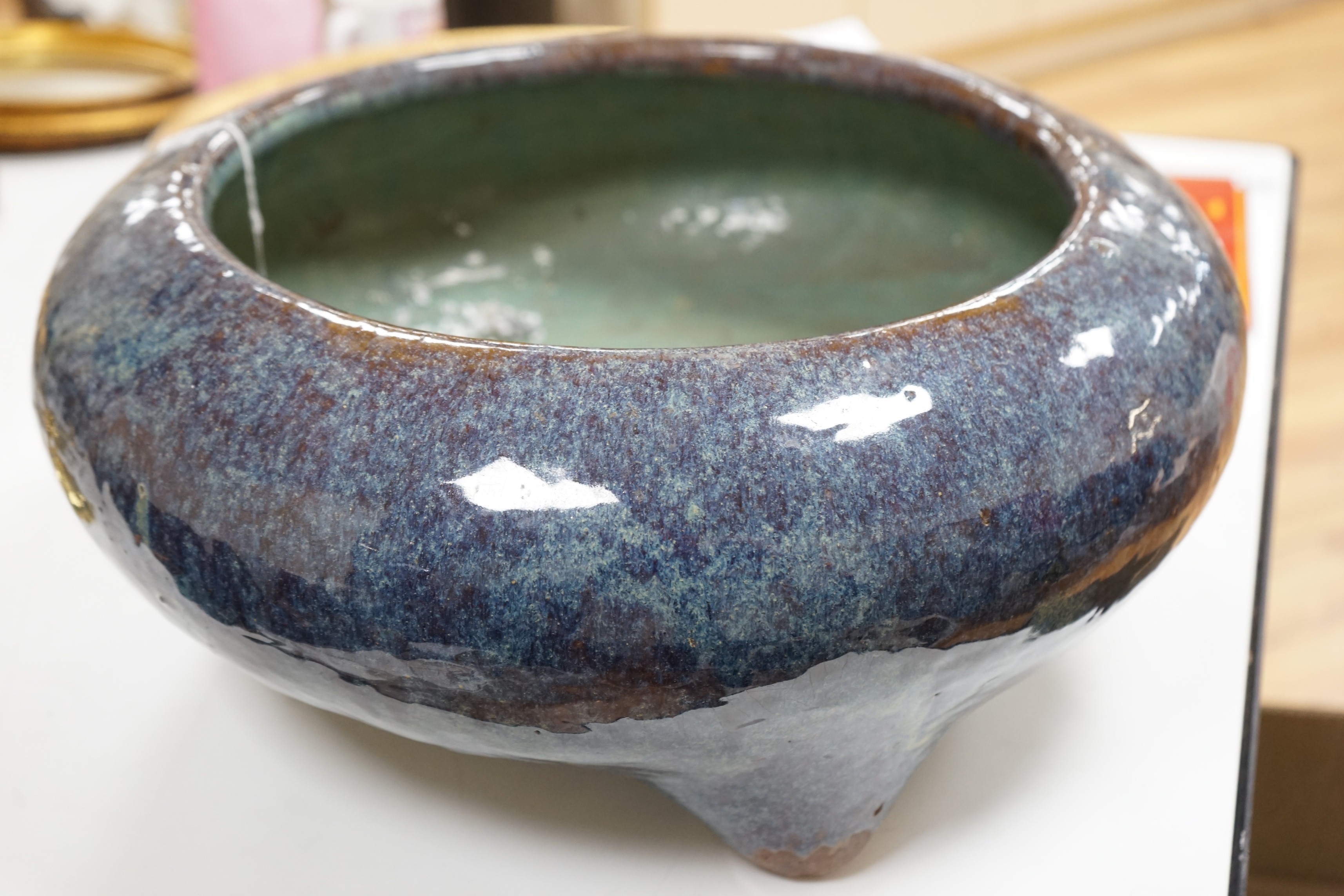 A large Chinese Shiwan stoneware tripod vessel or censer, late 19/early 20th century, 47cm diameter